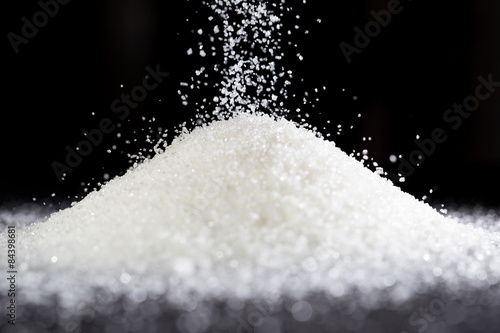 sugar on a black background photo