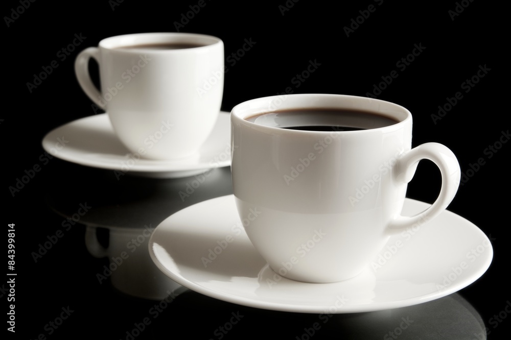 Cups of coffee with saucer isolated on black Cups of coffee with saucer isolated on black