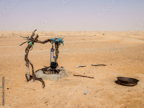Manmade drinking well with rope and bucket in Sahara Desert