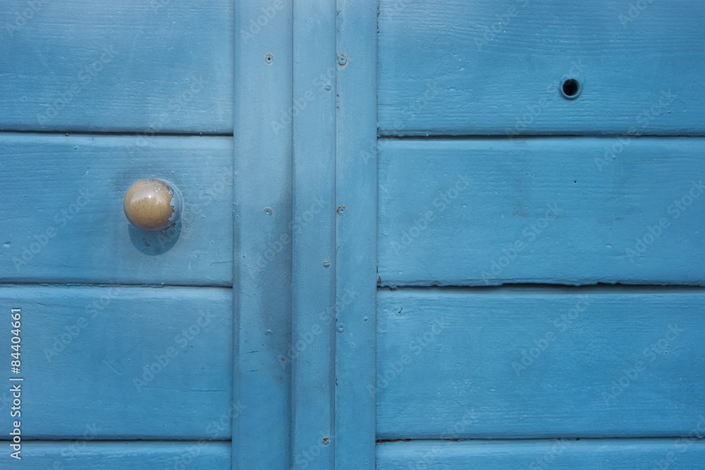 A detail of a light blue door
