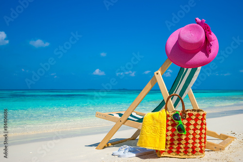 Fototapeta Naklejka Na Ścianę i Meble -  Beach chairs on the white sand beach with cloudy blue sky and sun