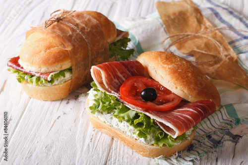 Sandwiches with jamon, soft cheese and fresh vegetables 