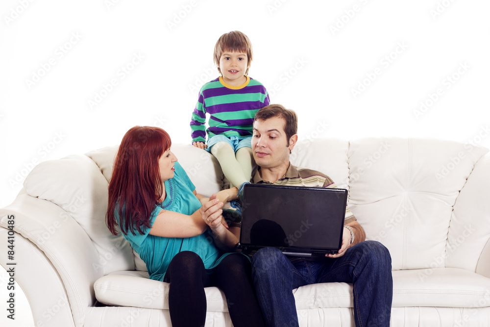 Father, mother and son sitting on the sofa with notebook Father, mother and son sitting on the sofa with notebook