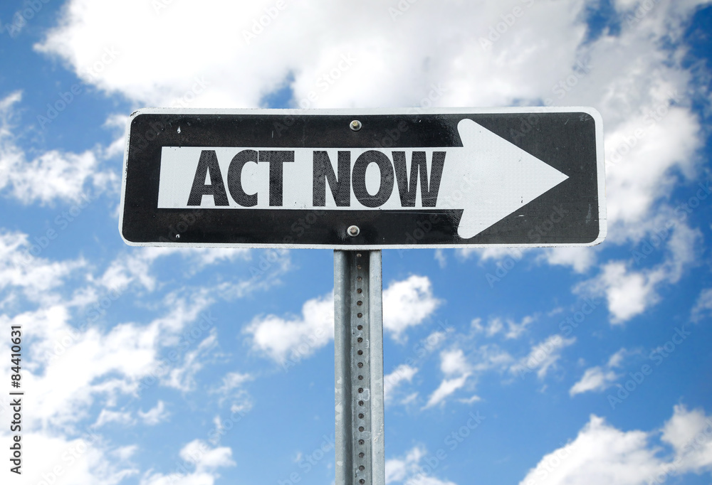 Act Now direction sign with sky background Act Now direction sign with sky background