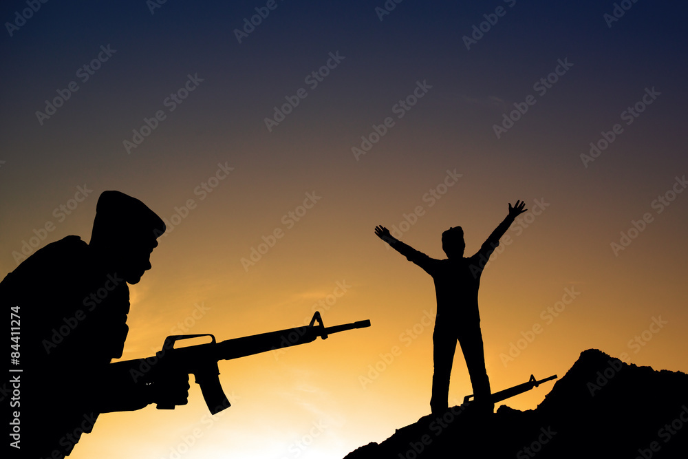 Silhouette shot of soldier holding gun Silhouette shot of soldier holding gun