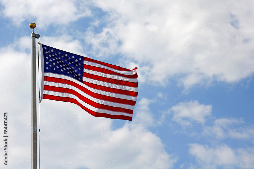 American Flag in front of Cloudy Blue Sky