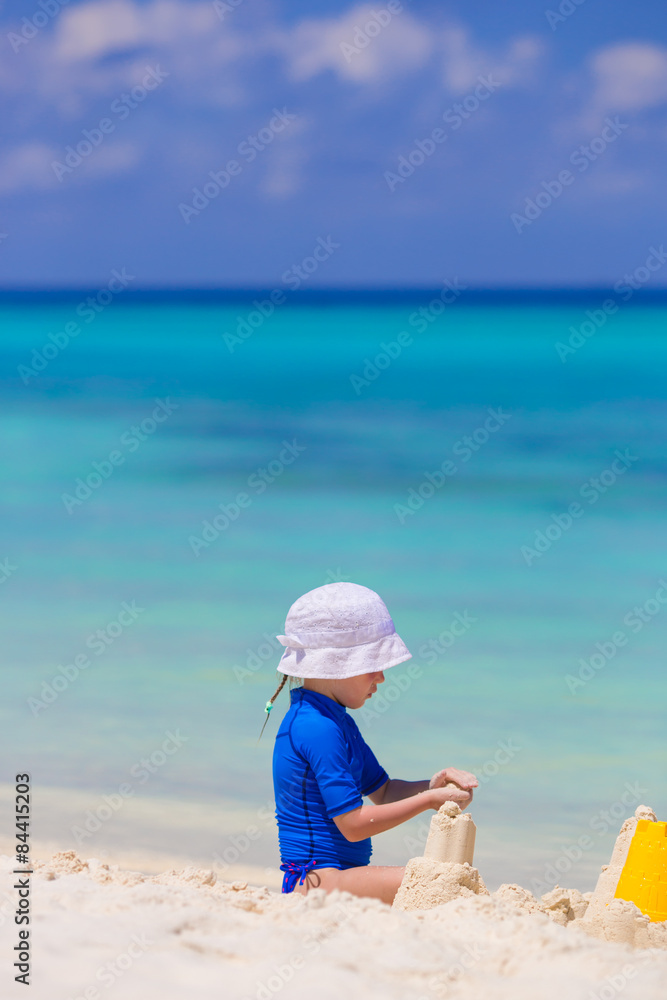 Adorable girl playing with beach toys during tropical vacation Adorable girl playing with beach toys during tropical vacation