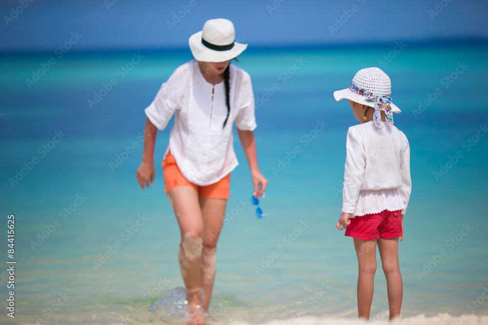 Little girl and young mother during beach vacation Little girl and young mother during beach vacation