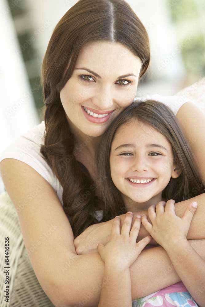 Fototapeta premium Mother And Daughter Relaxing Together In Chair