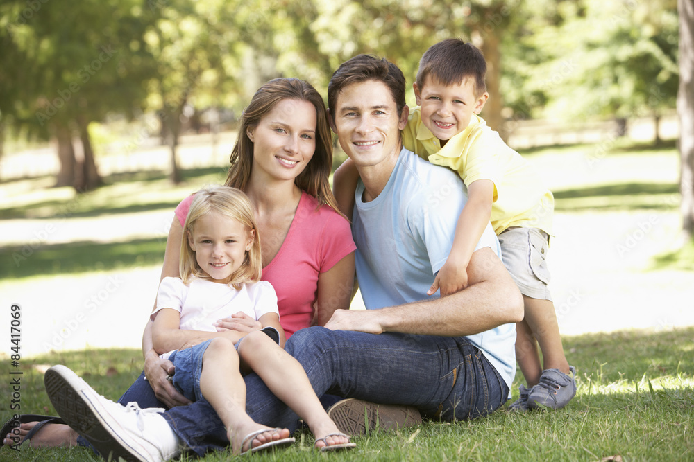 Young Family Sitting in Park
