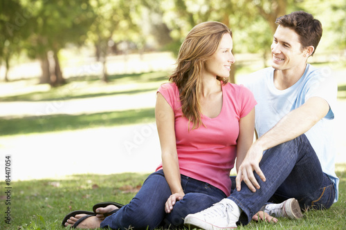 Young Couple Relaxing Together In Park