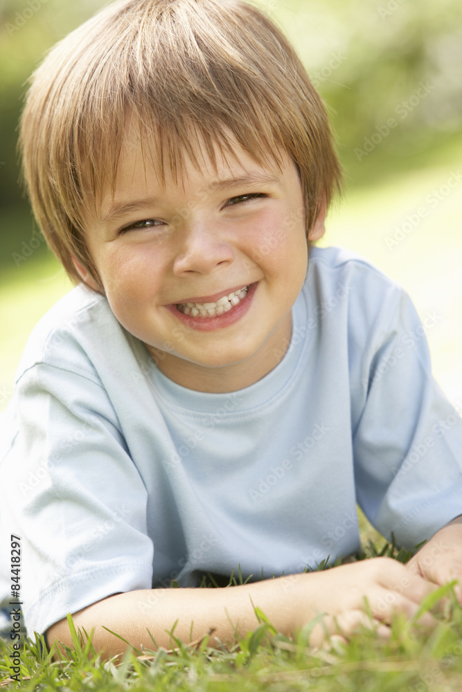 Portrait Of Young Boy Relaxing In Countryside Portrait Of Young Boy Relaxing In Countryside