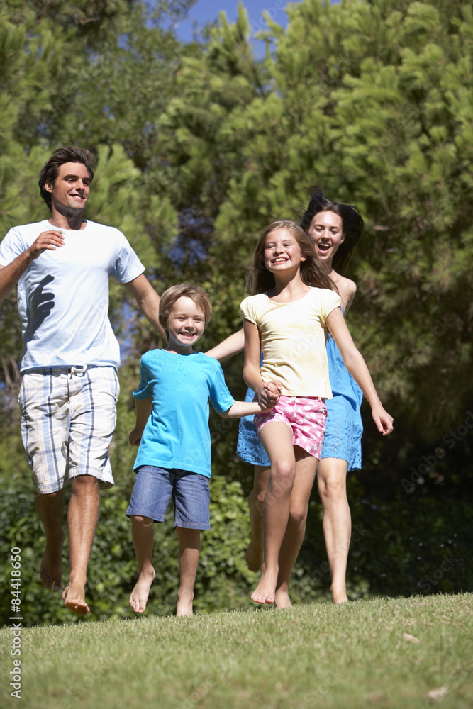 Young Family Running Through Summer Field Young Family Running Through Summer Field
