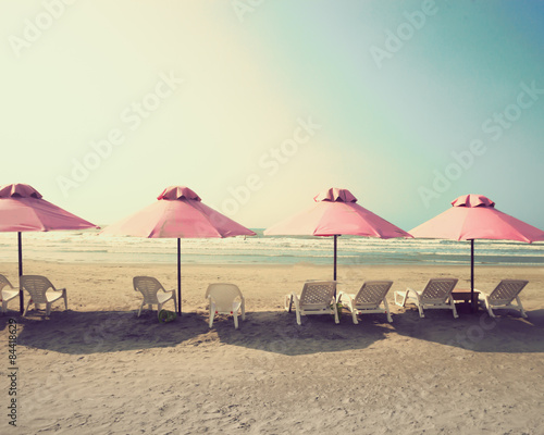 Retro beach with pink umbrellas