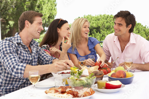 Group Of Young Friends Enjoying Outdoor Meal Together