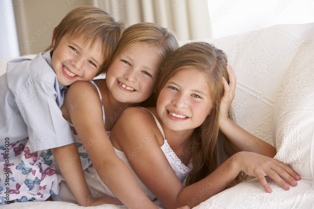 Group Of Children Relaxing On Sofa At Home Group Of Children Relaxing On Sofa At Home