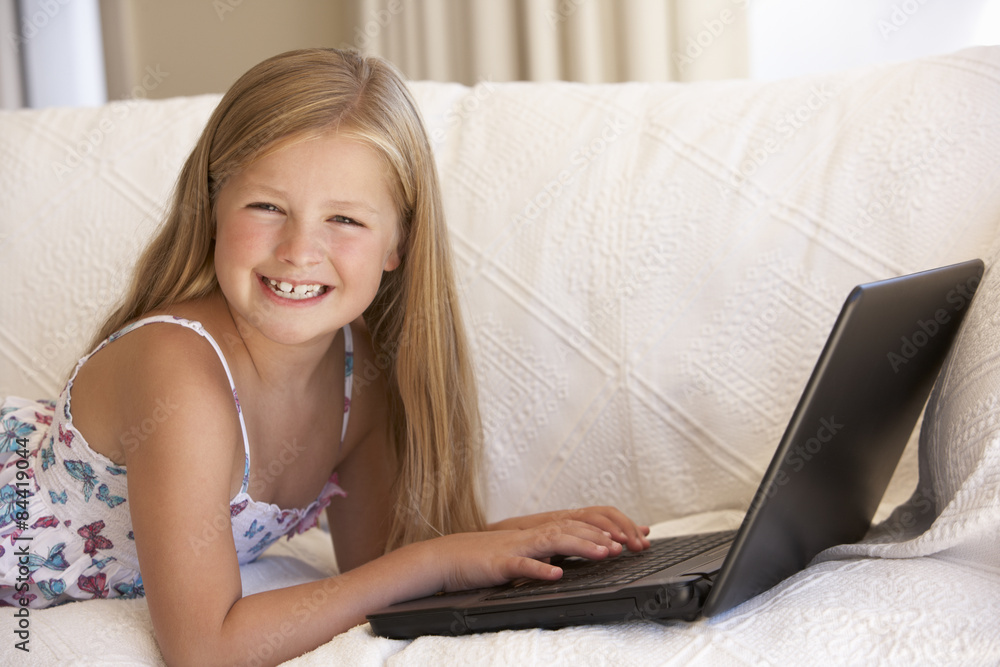 Young Girl Using Laptop At Home Young Girl Using Laptop At Home