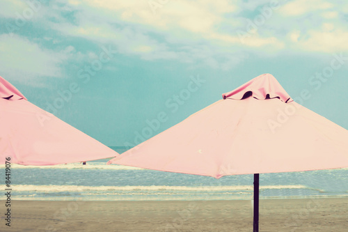 Retro beach with pink umbrellas