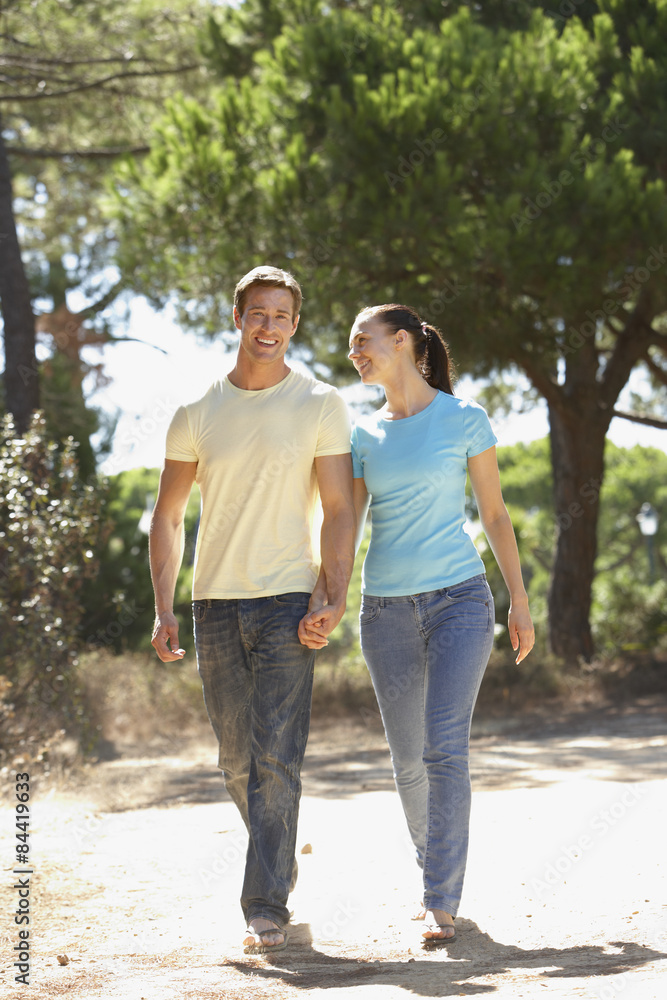 Young Couple On Romantic Walk In Countryside Young Couple On Romantic Walk In Countryside