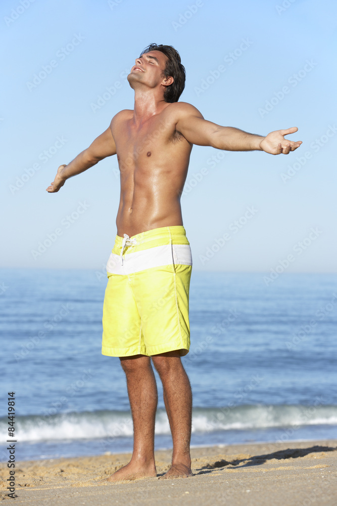 Young Man Standing On Summer Beach