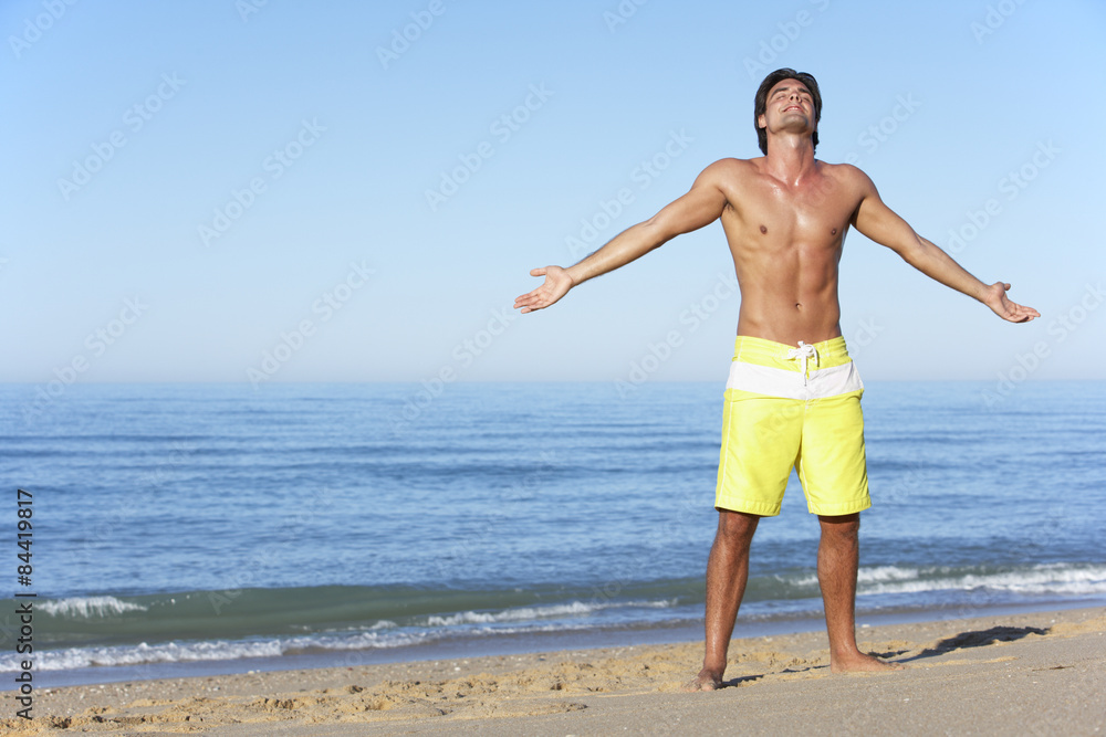 Young Man Standing On Summer Beach