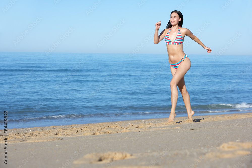 Young Woman Running Along Summer Beach Young Woman Running Along Summer Beach