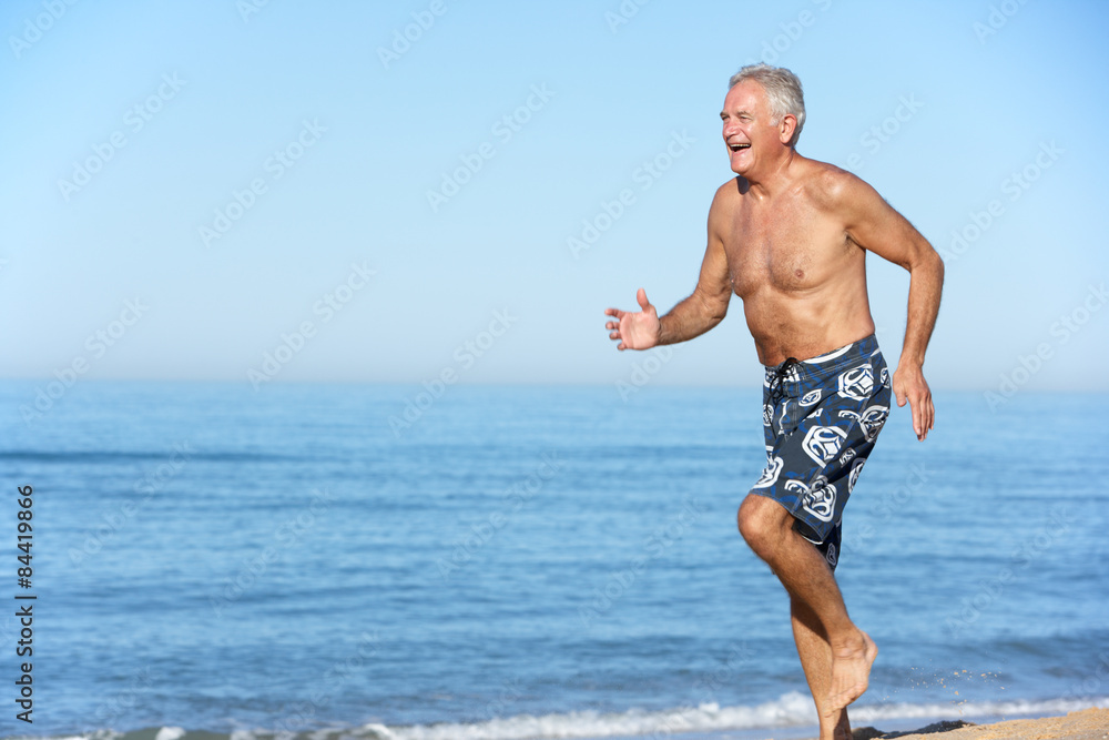 Senior Man Running Along Summer Beach