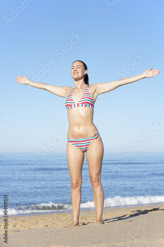 Young Woman Standing On Summer Beach