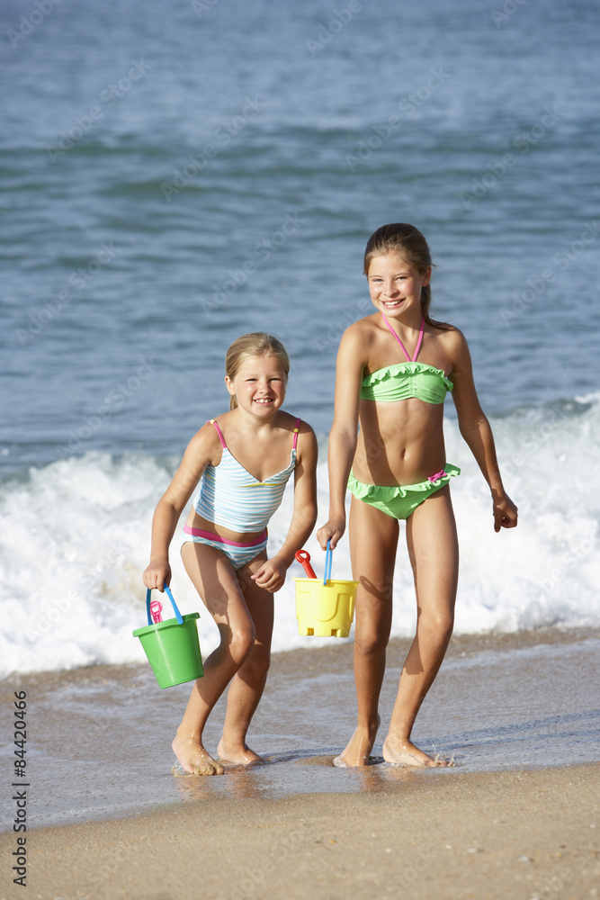 Two Young Girls Enjoying Beach Holiday