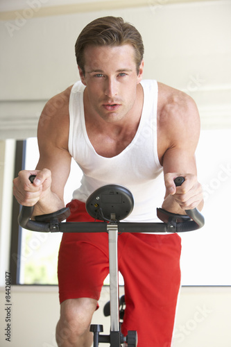 Young Man On Exercise Bike