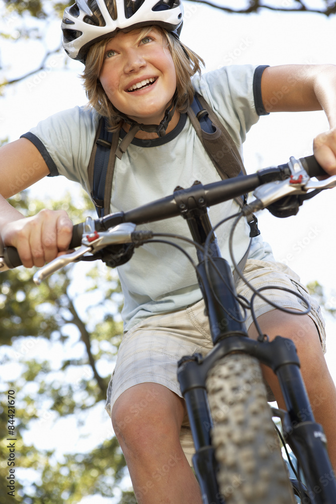 Obraz premium Teenage Boy Cycling Through Countryside