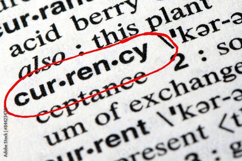 Closeup of the word currency in the English dictionary
