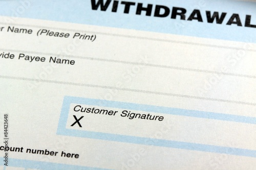 Withdrawal slip from bank checking or savings account - Finance and accounting concept