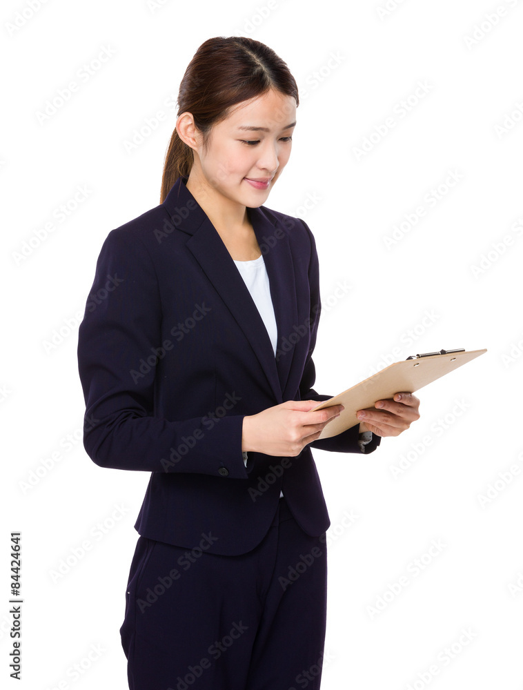 Businesswoman read on clipboard Businesswoman read on clipboard