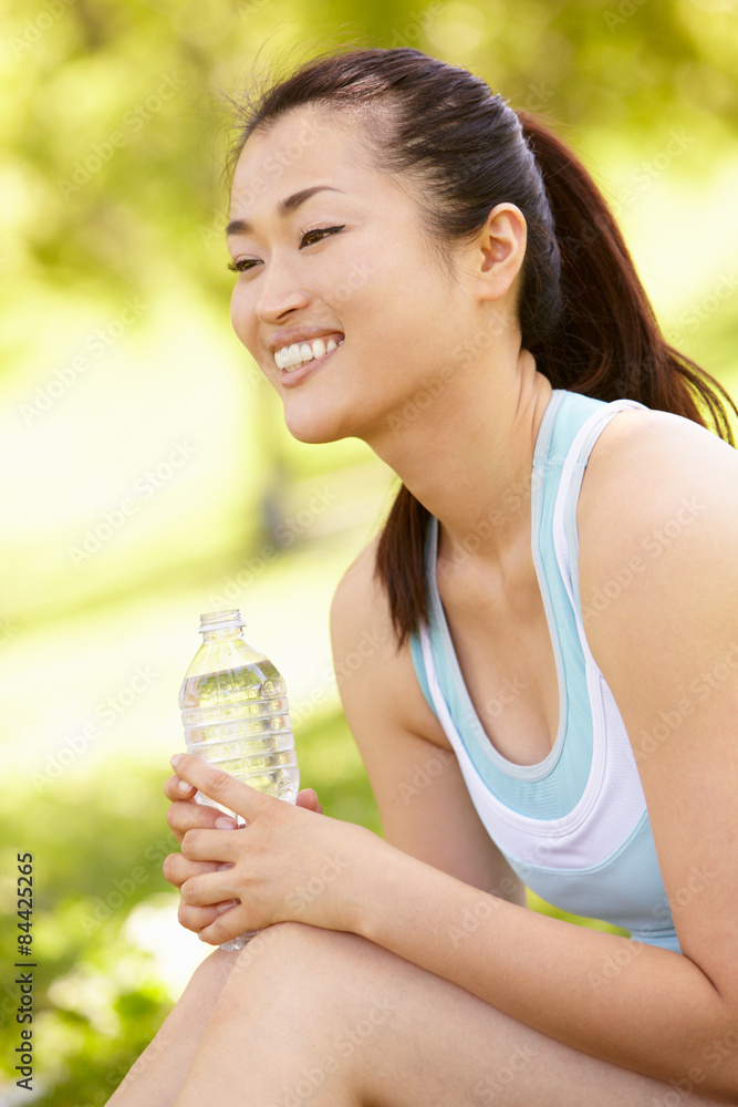 Asian woman resting after exercise Asian woman resting after exercise