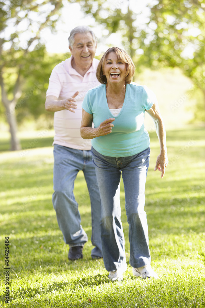 Fototapeta premium Senior Hispanic Couple Running In Park