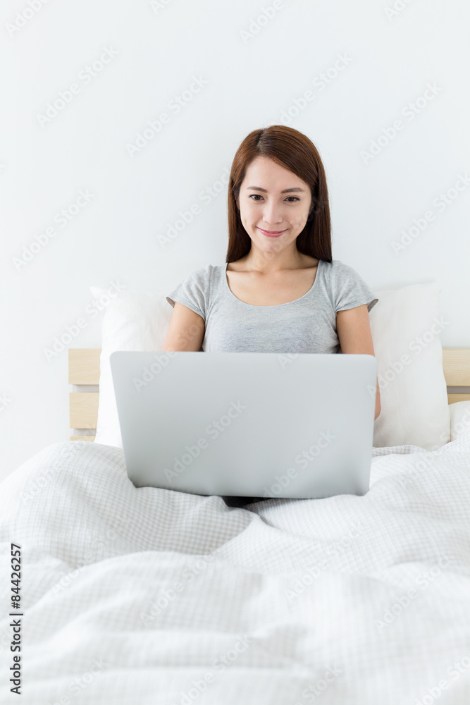 Asian woman using the laptop computer at morning Asian woman using the laptop computer at morning
