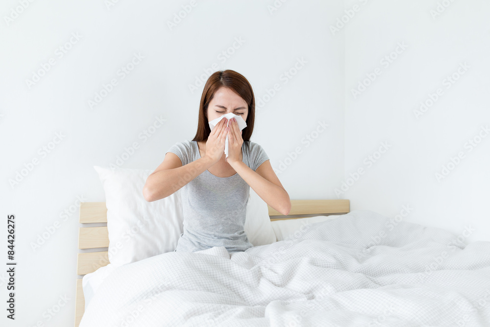 Young lady sneeze on the bed and need more rest Young lady sneeze on the bed and need more rest