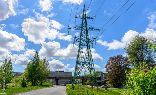 High voltage tower with cloudy sky on background
