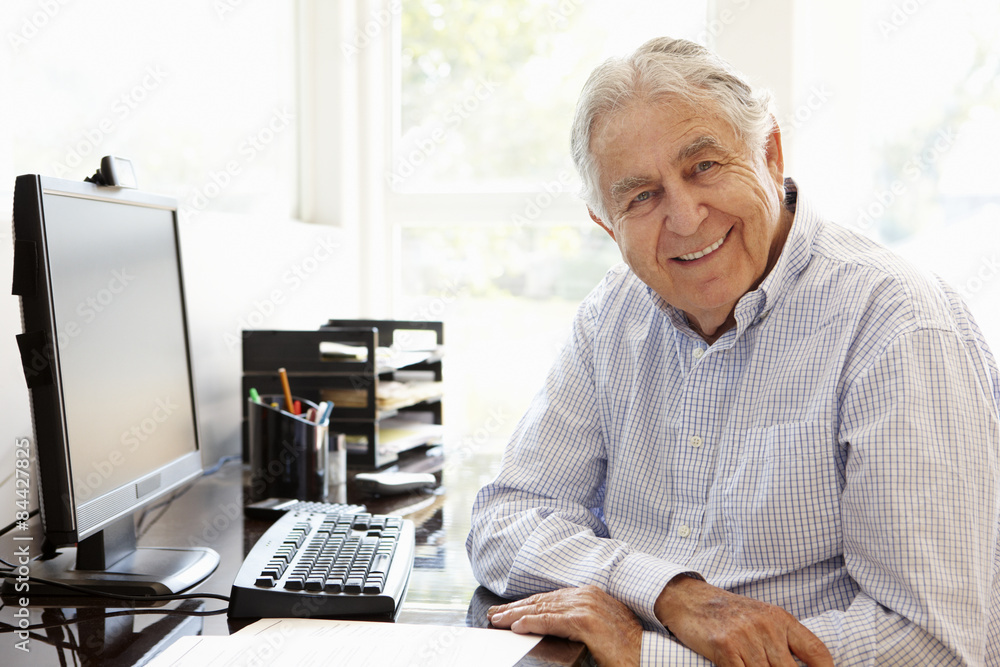 Senior Hispanic man working on computer at home Senior Hispanic man working on computer at home