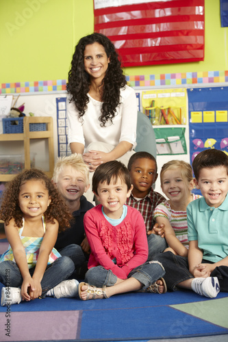 Group Of Elementary Age Schoolchildren In Class With Teacher