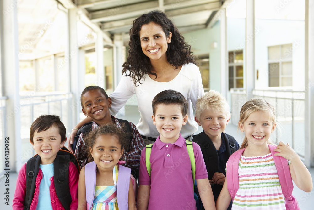 Group Of Elementary Age Schoolchildren Standing Outside With Teacher