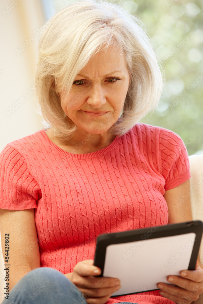 Mid age woman using tablet at home Mid age woman using tablet at home