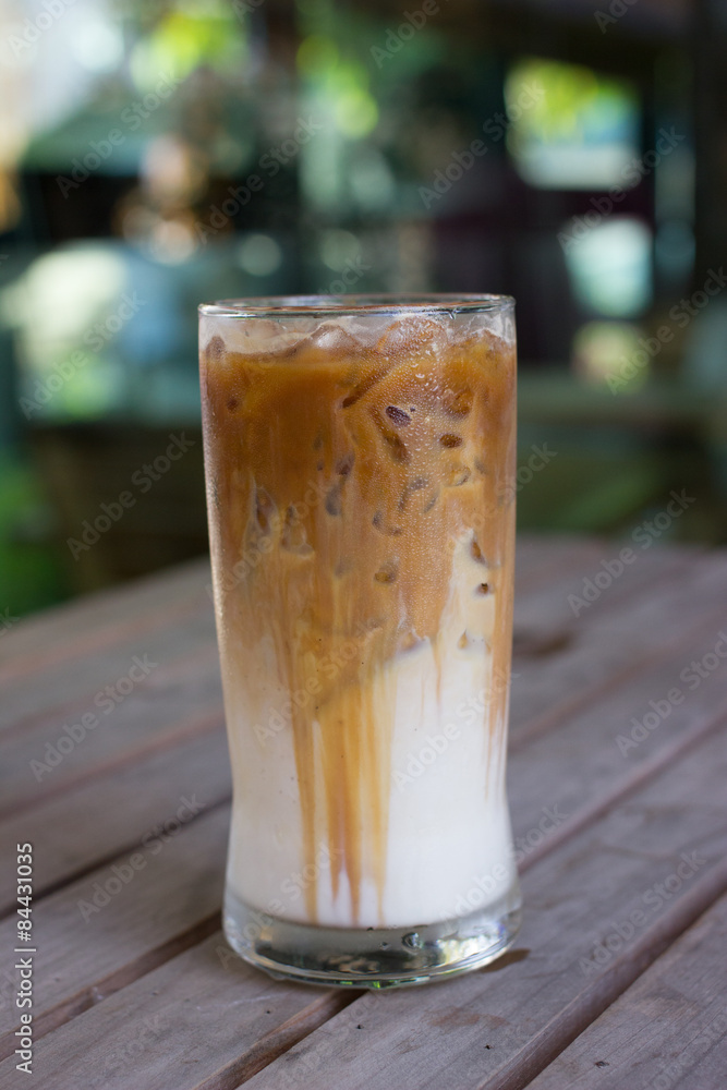 Iced coffee with milk is on the table.