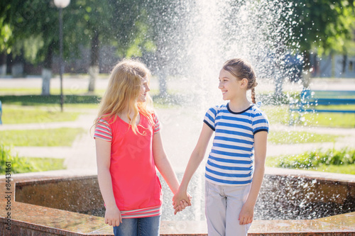 two happy girls at the fountain photo