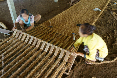 Asian worker, coir mat , Vietnamese, coconut fiber photo