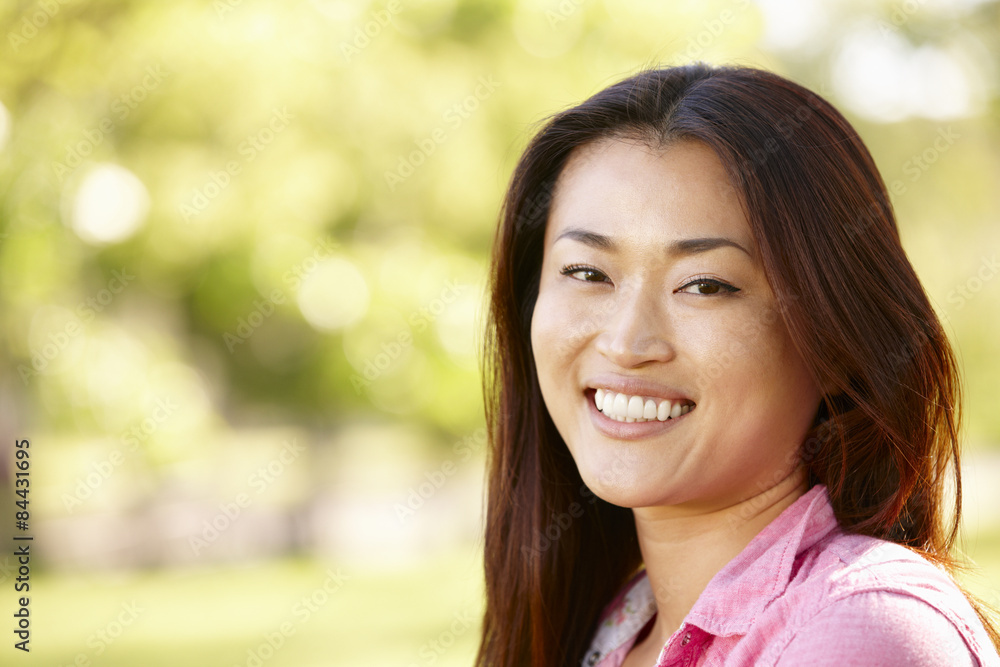 Head and shoulders portrait Asian woman outdoors Head and shoulders portrait Asian woman outdoors