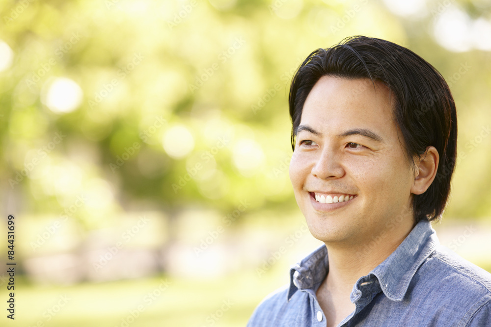 Head and shoulders portrait Asian man outdoors Head and shoulders portrait Asian man outdoors