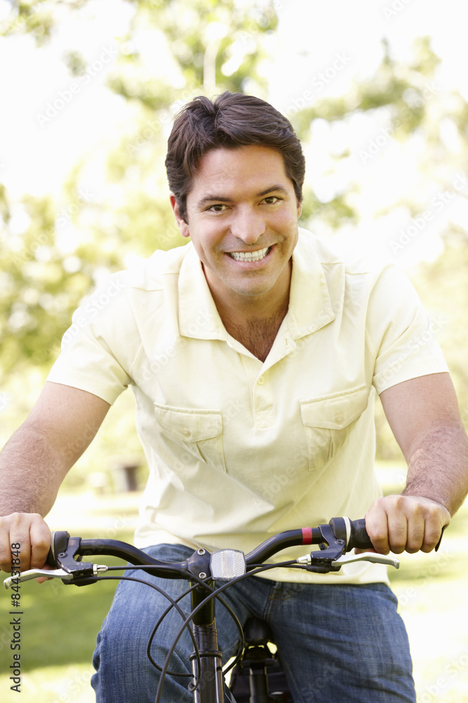 Obraz premium Young Hispanic Man Cycling In Park