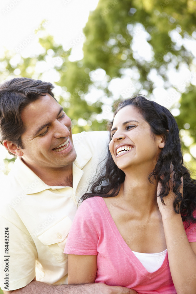 Romantic Young Hispanic Couple Relaxing In Park Romantic Young Hispanic Couple Relaxing In Park